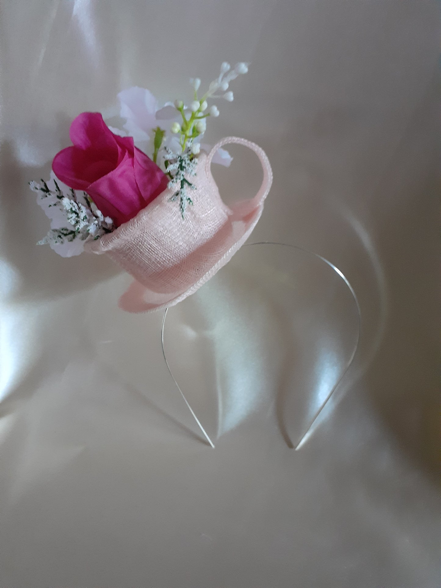 Pink sinamay cup and saucer headpiece