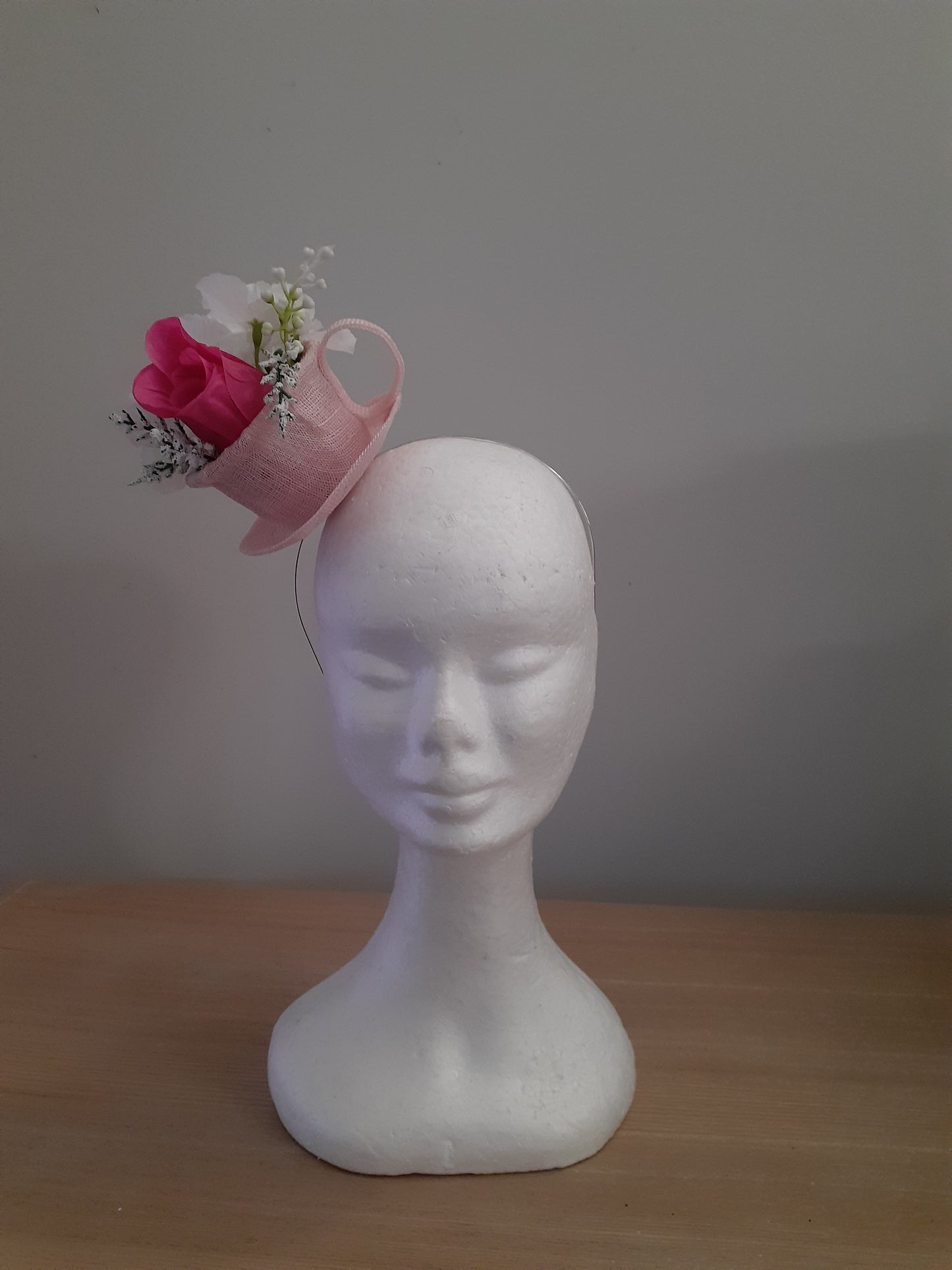 Pink sinamay cup and saucer headpiece